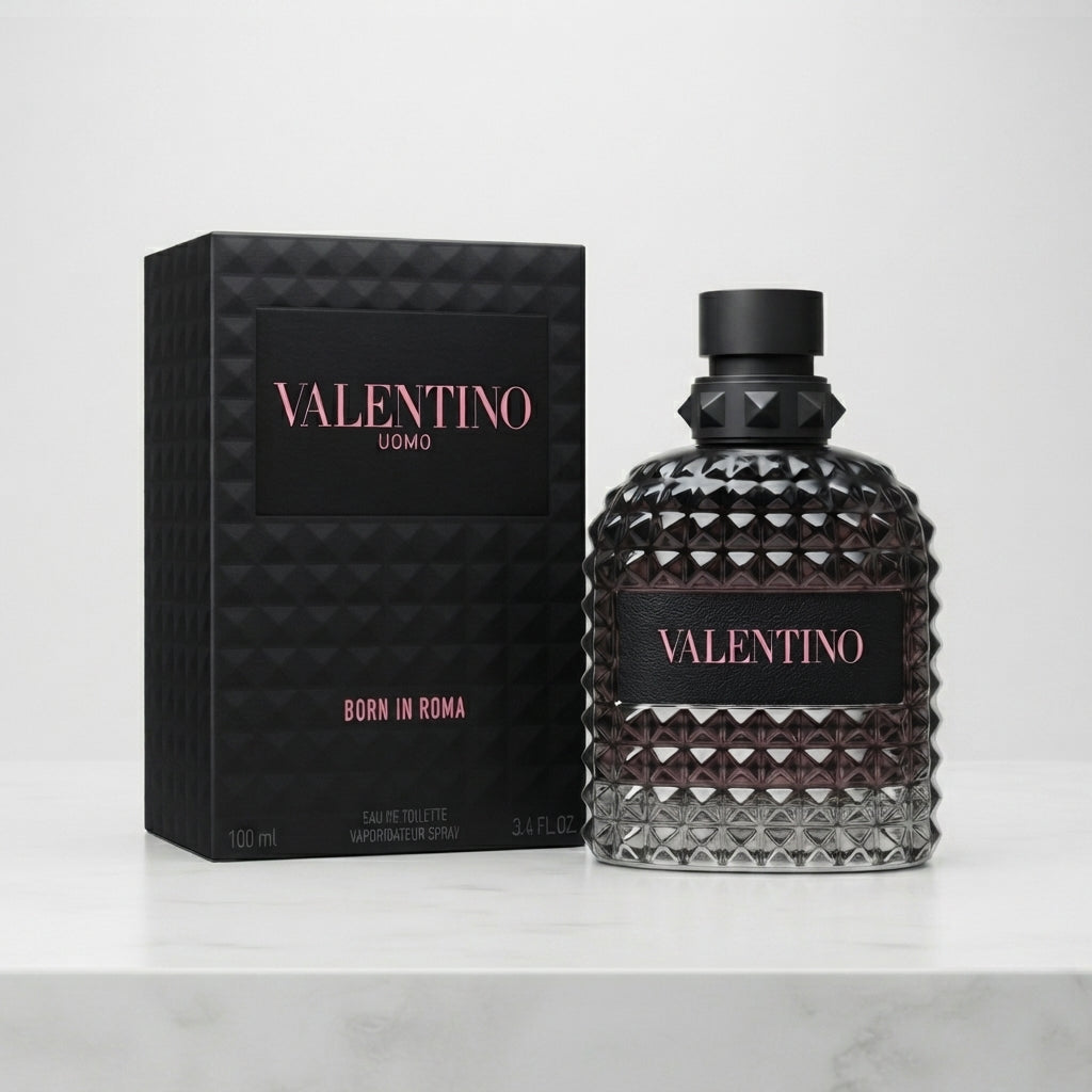 Valentino Uomo Born in Roma Eau de Toilette bottle and its black textured packaging box, displayed on a light marble surface against a white background.